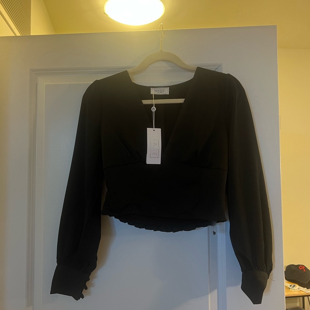 Black long sleeve blouse with slight crop top.